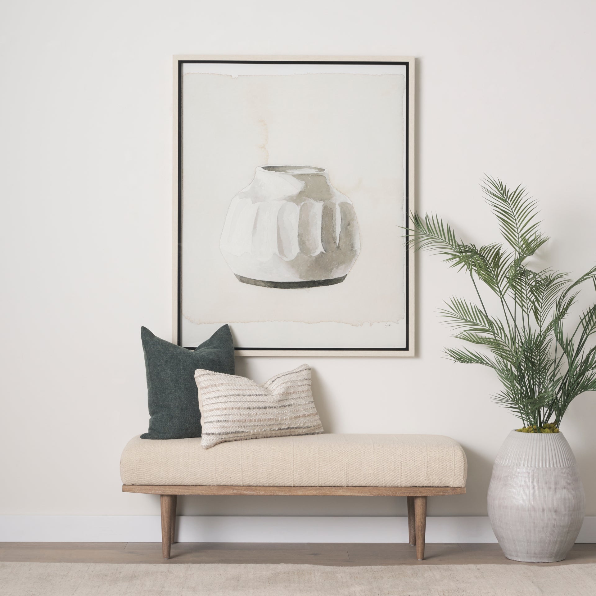 Front view of the Shae bench featuring a plush oatmeal-colored upholstered seat and a tapered brown wood frame