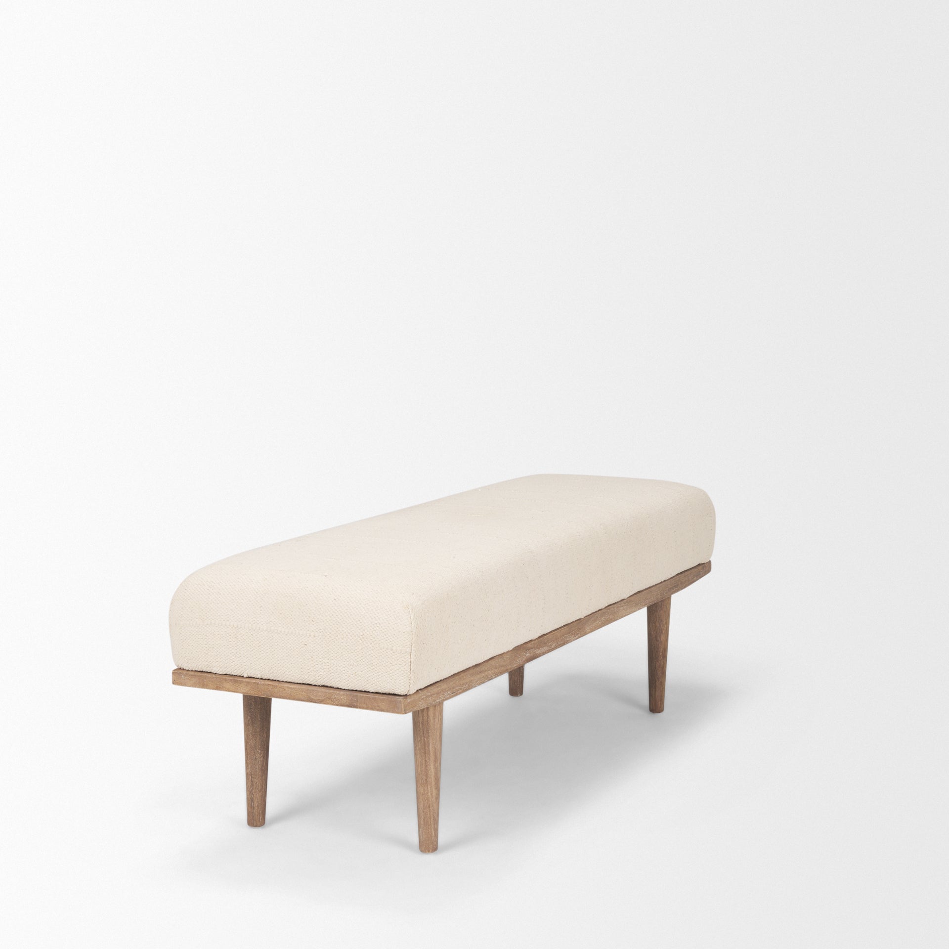 Front view of the Shae bench featuring a plush oatmeal-colored upholstered seat and a tapered brown wood frame
