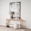 Lifestyle shot of the Siren cream stool styled in a neutral entryway tucked under a light wood console table