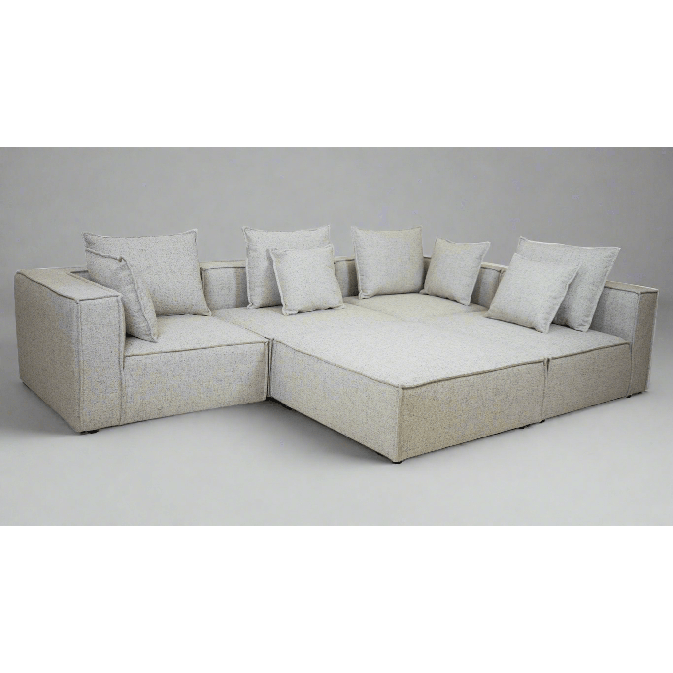 Full view of the Skive 5 Piece Modular Set in Quartz grey fabric featuring multiple matching back pillows