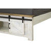 Close-up shot of the footboard featuring functional sliding barn doors and an open center storage compartment