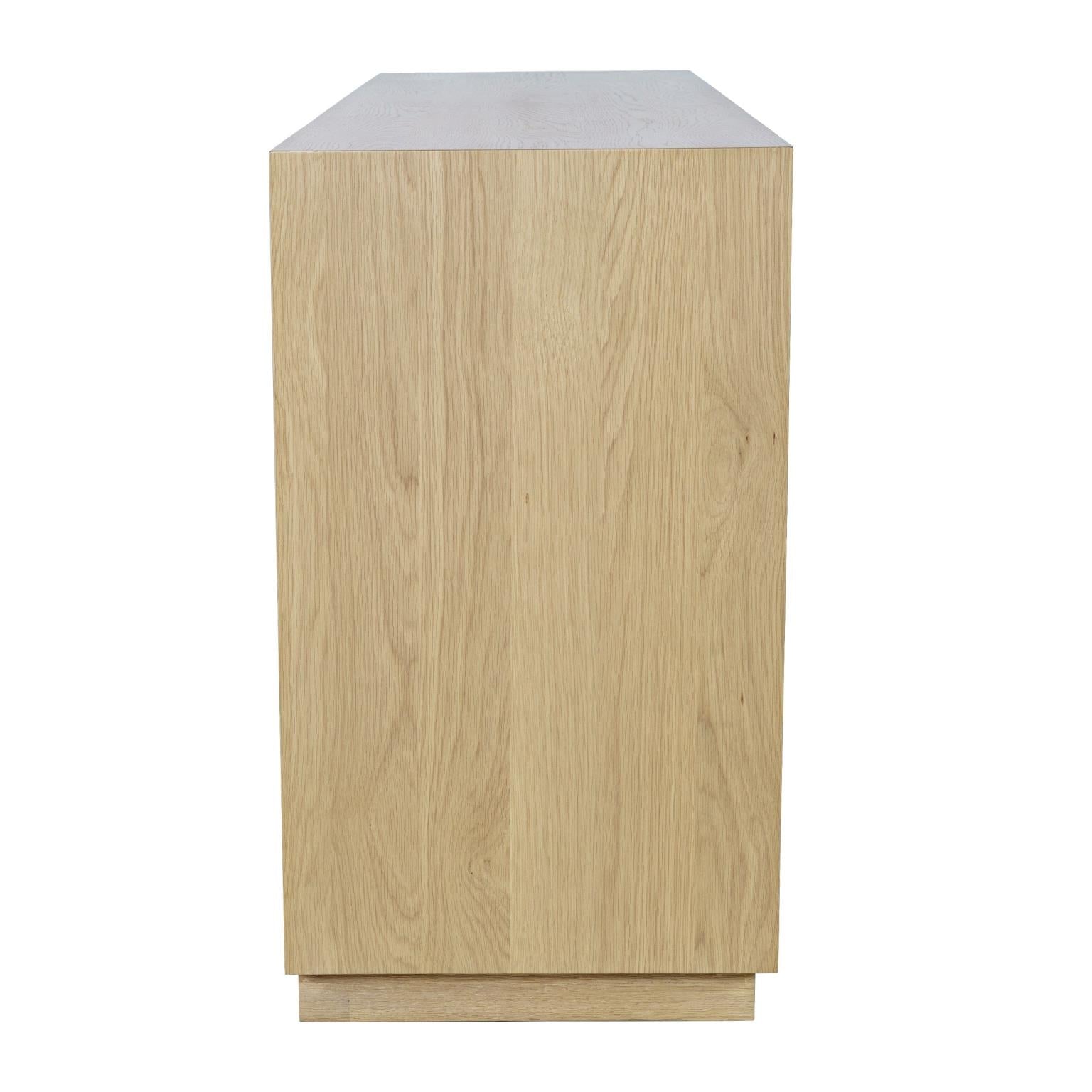 Front perspective view of the Skap 4-door sideboard in a dark oak finish featuring vertical fluted door panels and a matching plinth base