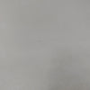Macro top-down detail shot highlighting the uniform smooth finish and subtle matte texture of the concrete surface