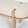 Close-up of the bench corner highlighting the refined wood joinery where the elm frame cradles the oatmeal fabric seat