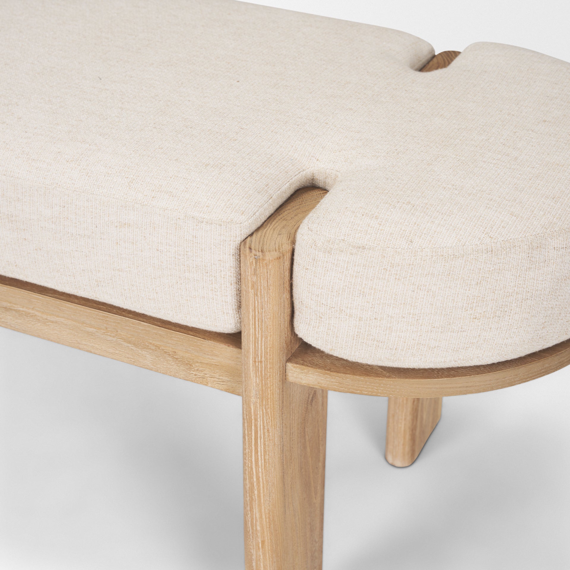 Front view of the Sohan bench featuring a light brown elm wood frame and an oatmeal-colored upholstered seat
