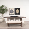 Studio lifestyle shot featuring the Sohan dark elm table styled with a matching upholstered bench and minimalist wall art