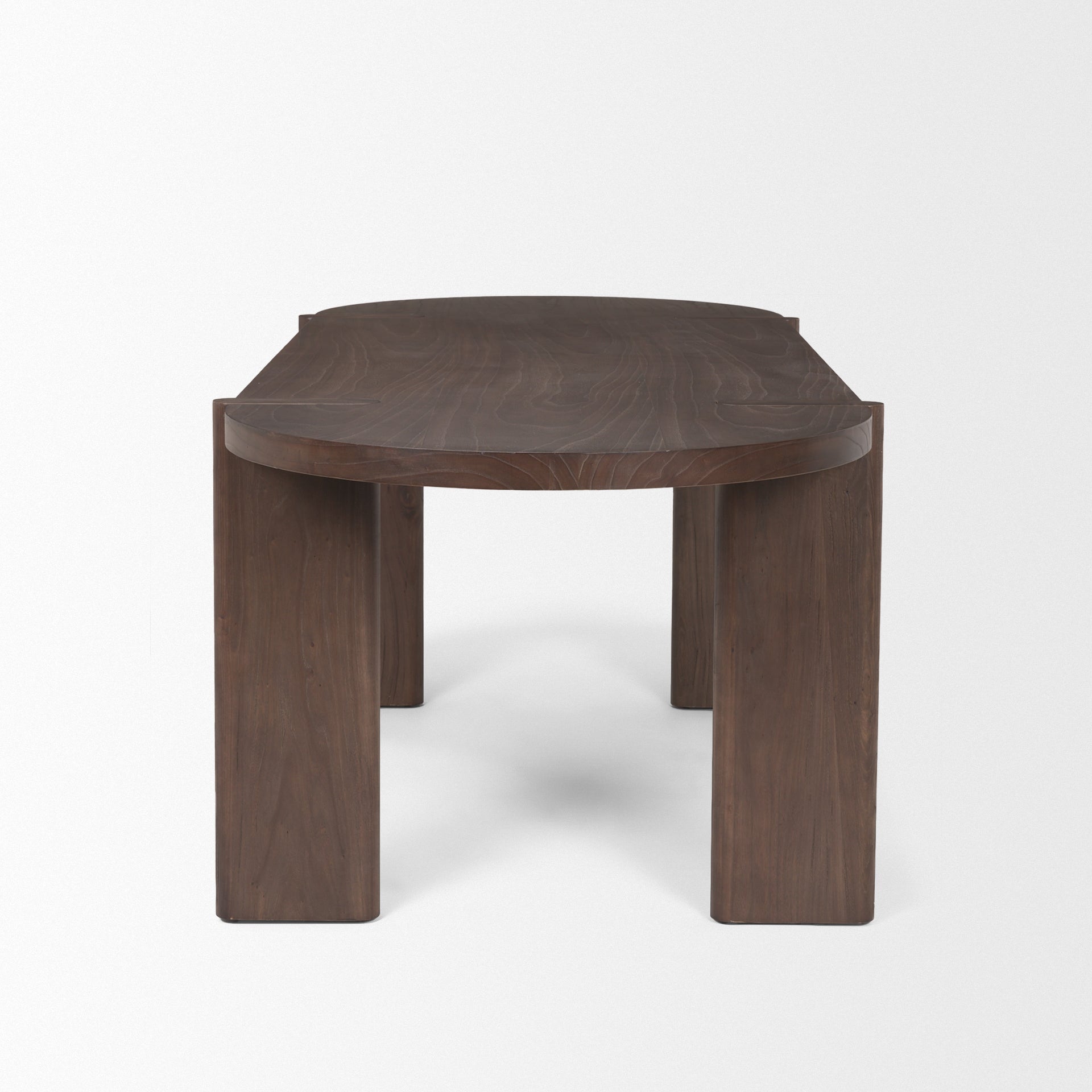 Front view of the Sohan oval dining table in a dark elm wood finish featuring smooth rounded edges and sturdy trestle leg supports
