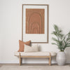 Lifestyle shot of the Sohan bench styled in a minimalist entryway with a large framed art piece and potted plant