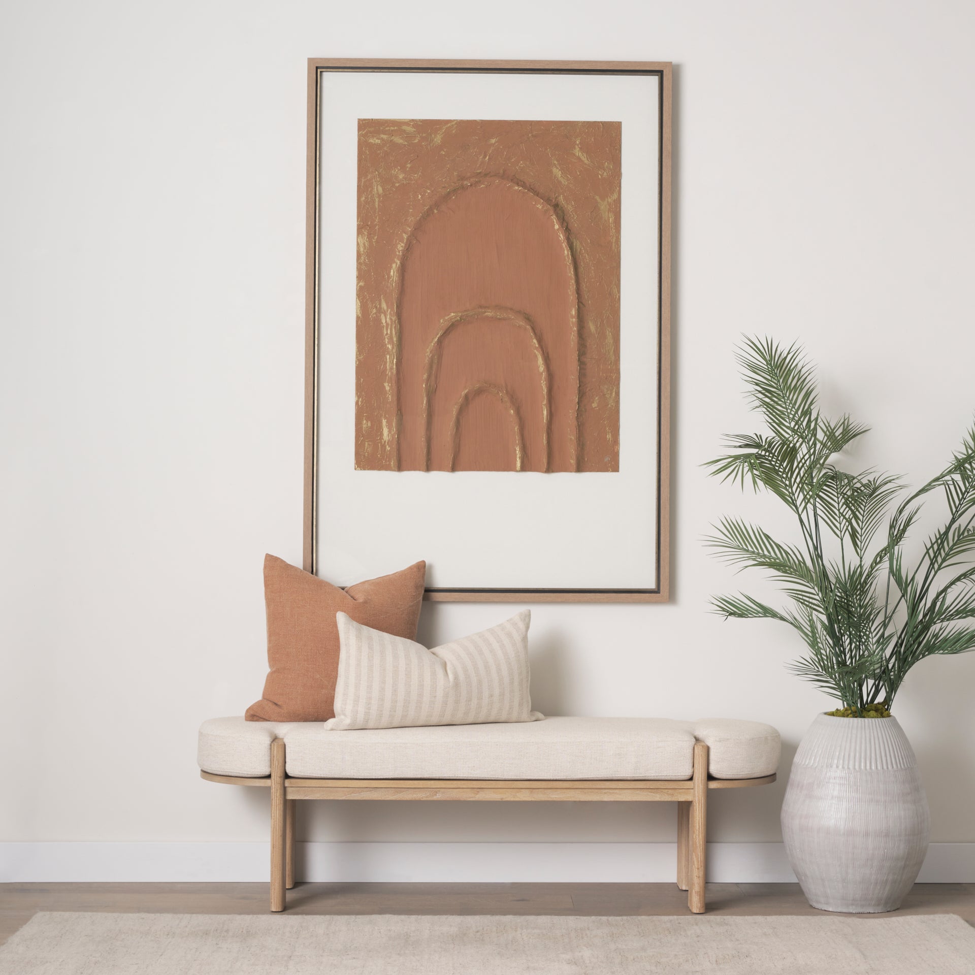Front view of the Sohan bench featuring a light brown elm wood frame and an oatmeal-colored upholstered seat