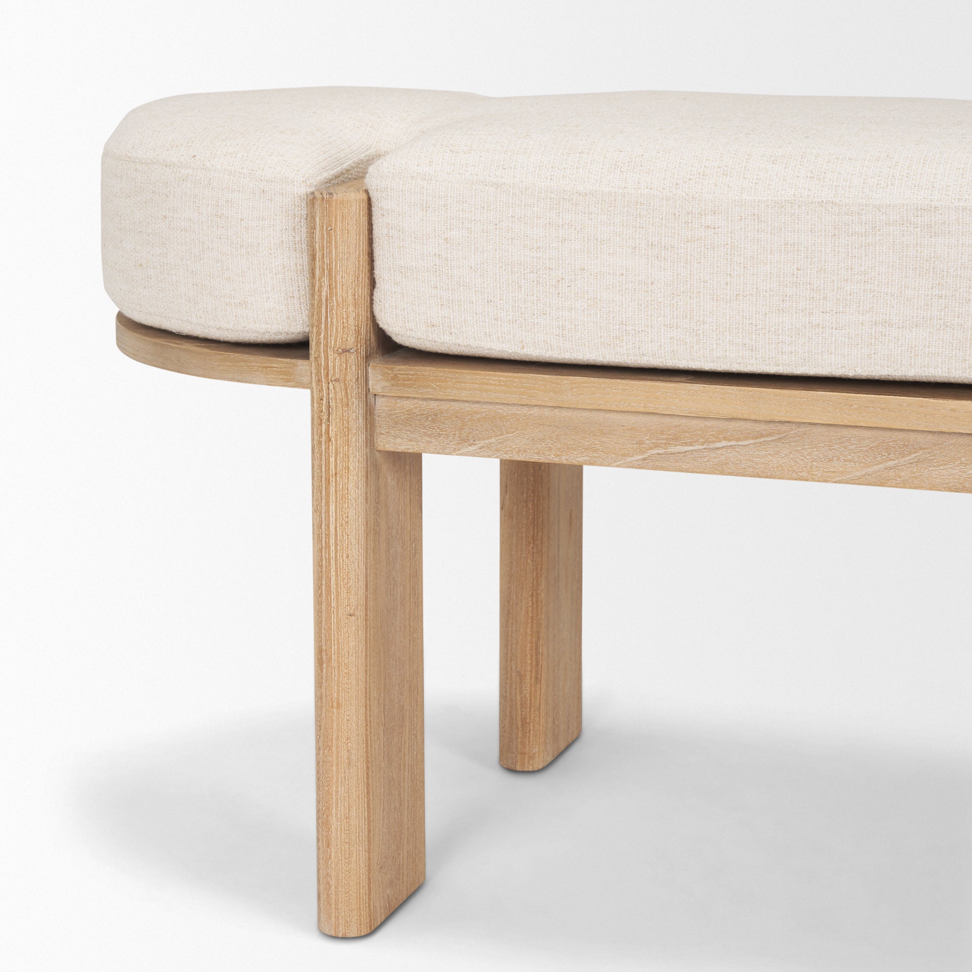 Front view of the Sohan bench featuring a light brown elm wood frame and an oatmeal-colored upholstered seat