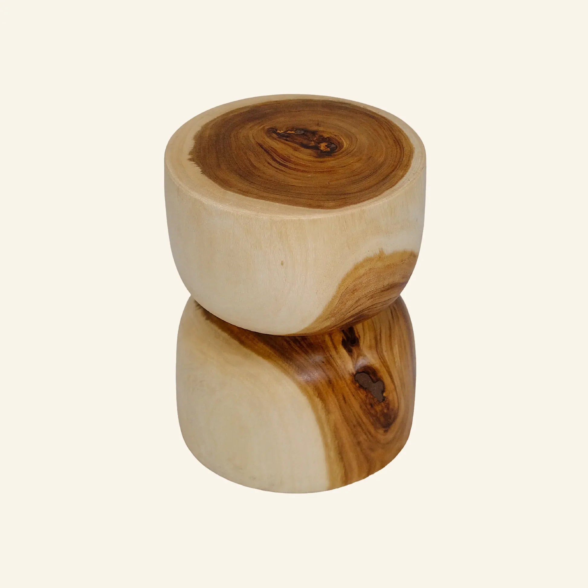 High-angle view of a solid suar wood stool featuring a sculptural hourglass silhouette and vibrant natural grain patterns with distinct heartwood and sapwood contrast