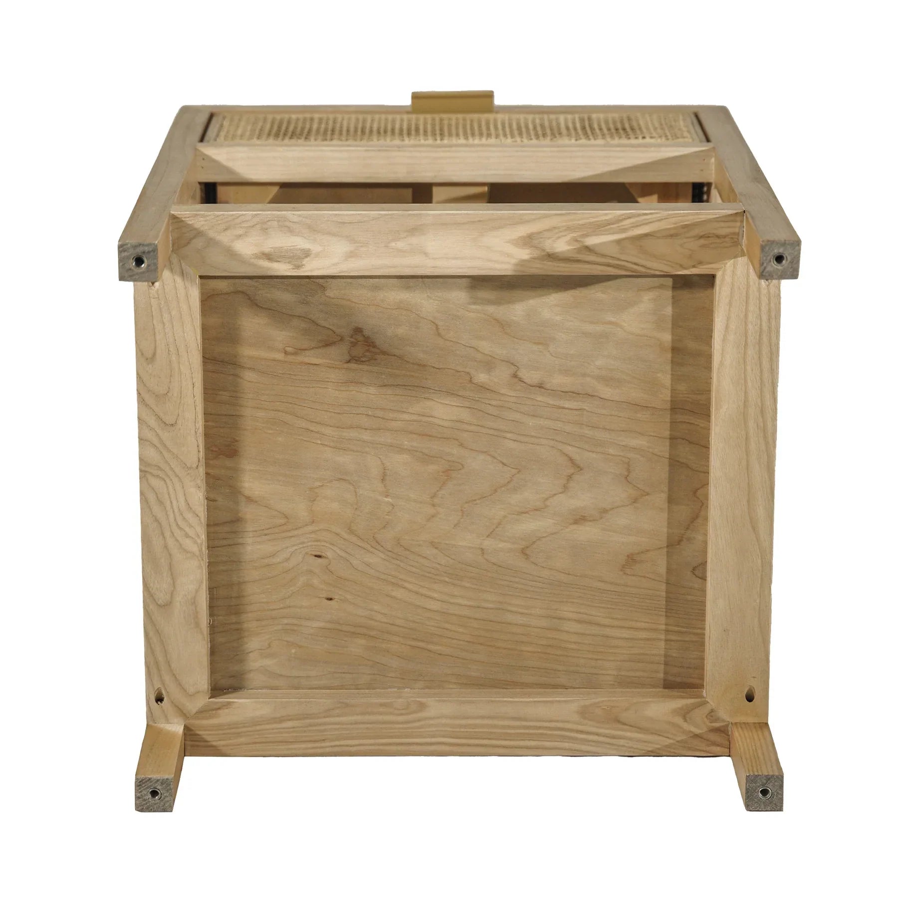 Straight-on front view showcasing the woven rattan drawer front and minimalist brass hardware on a light wood frame
