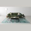 Lifestyle perspective showing the nesting tables paired with a forest green upholstered sofa and neutral decor