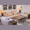 Wide lifestyle view showcasing the Sona tables within a full furniture collection including a peach sofa and white armchairs