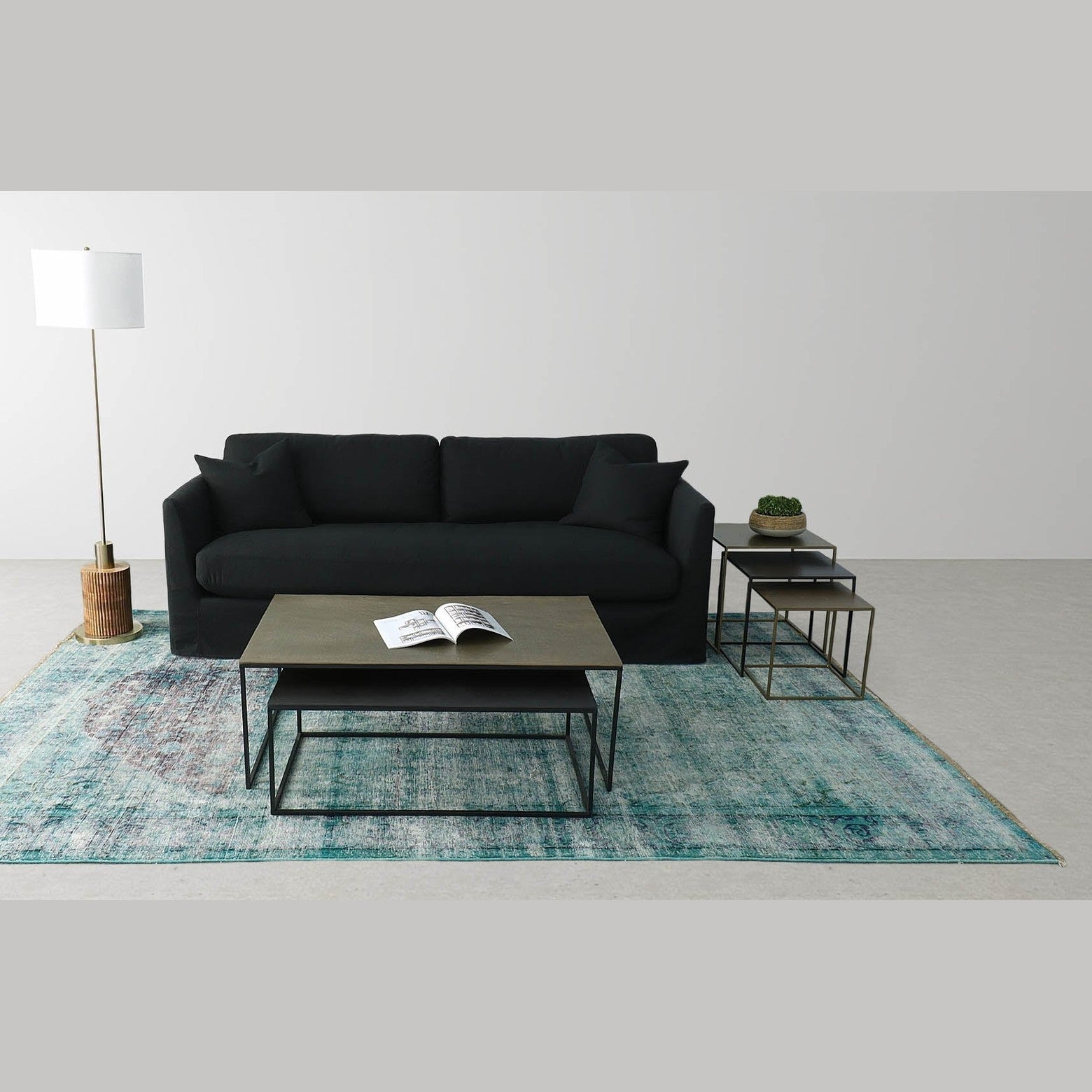 Front view of the Sona nesting table set featuring two square tables with bronze-toned tops and minimalist black metal frames