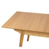 Perspective view showing the internal butterfly leaf extension mechanism being deployed to increase the table's seating capacity