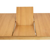 Close-up view showing the center of the table opened to reveal the integrated storage for the butterfly extension leaf