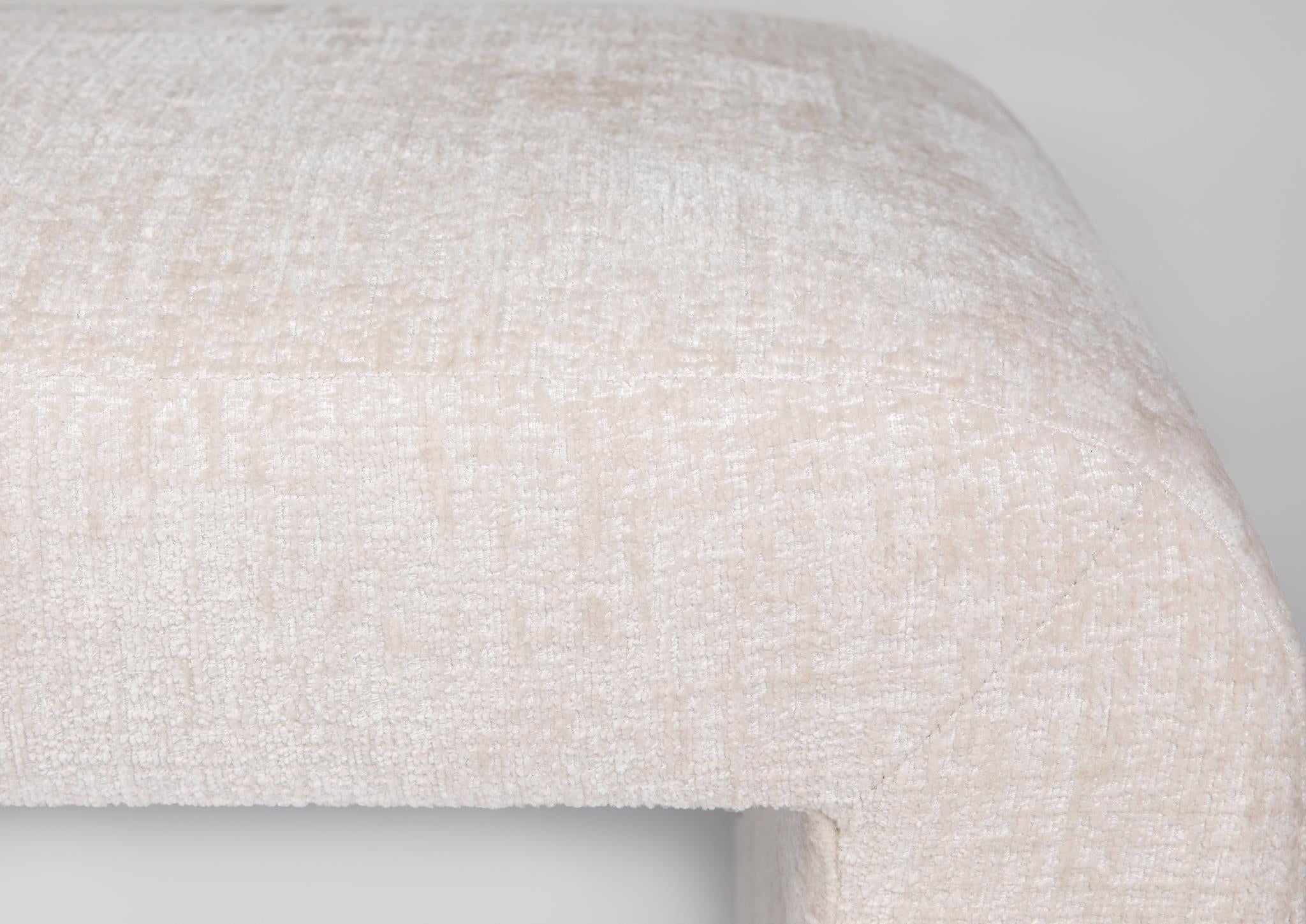 Front view of the Sophia large accent bench featuring a seamless waterfall silhouette and cream textured upholstery