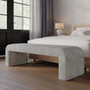 Lifestyle shot featuring the light gray Sophia bench positioned at the base of a modern bed frame