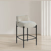 Lifestyle shot of the Sorte cream fabric counter stool styled in a modern kitchen setting
