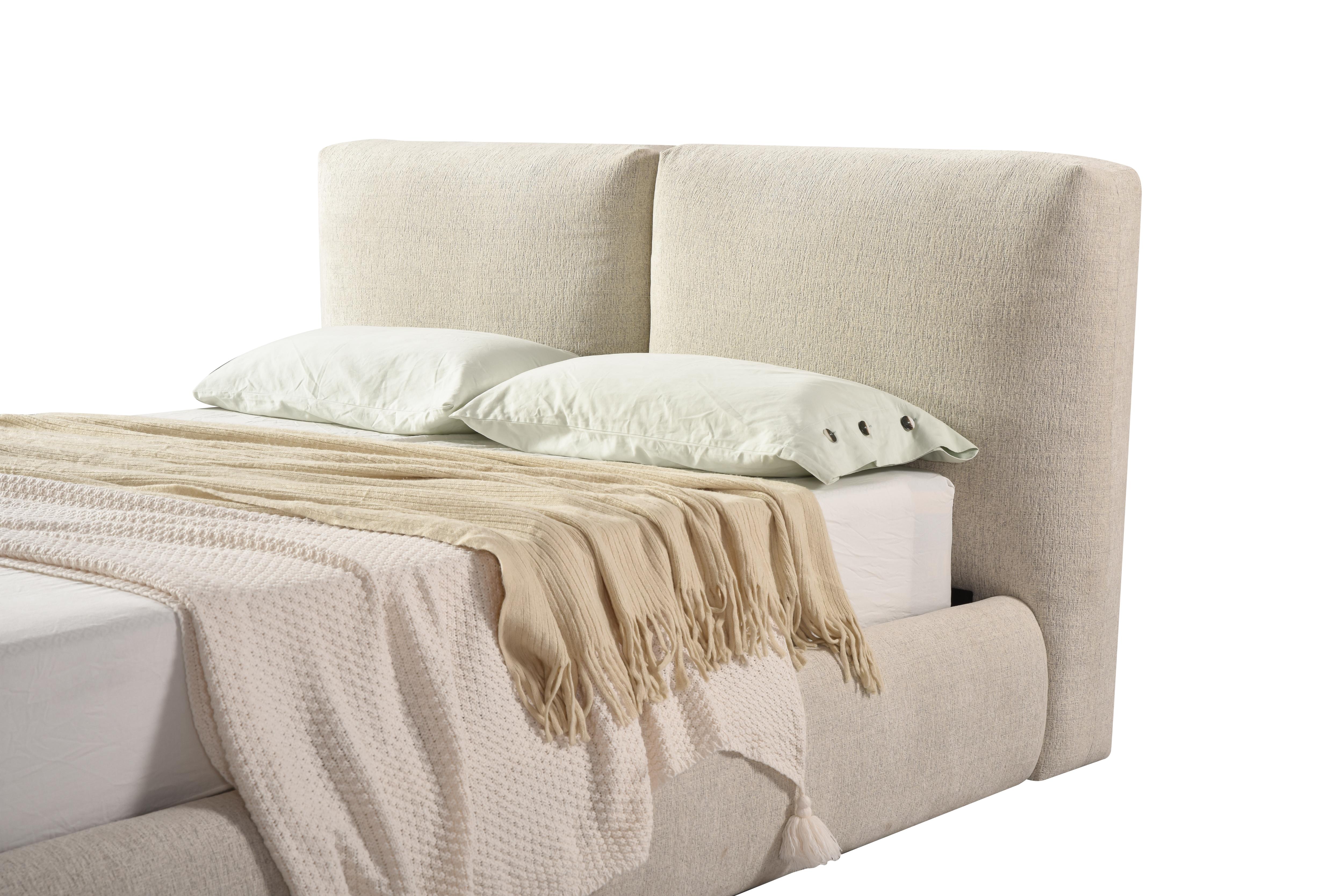 Front view of the Drom upholstered storage bed featuring a low-profile cream bouclé frame and a unique split-panel cushioned headboard