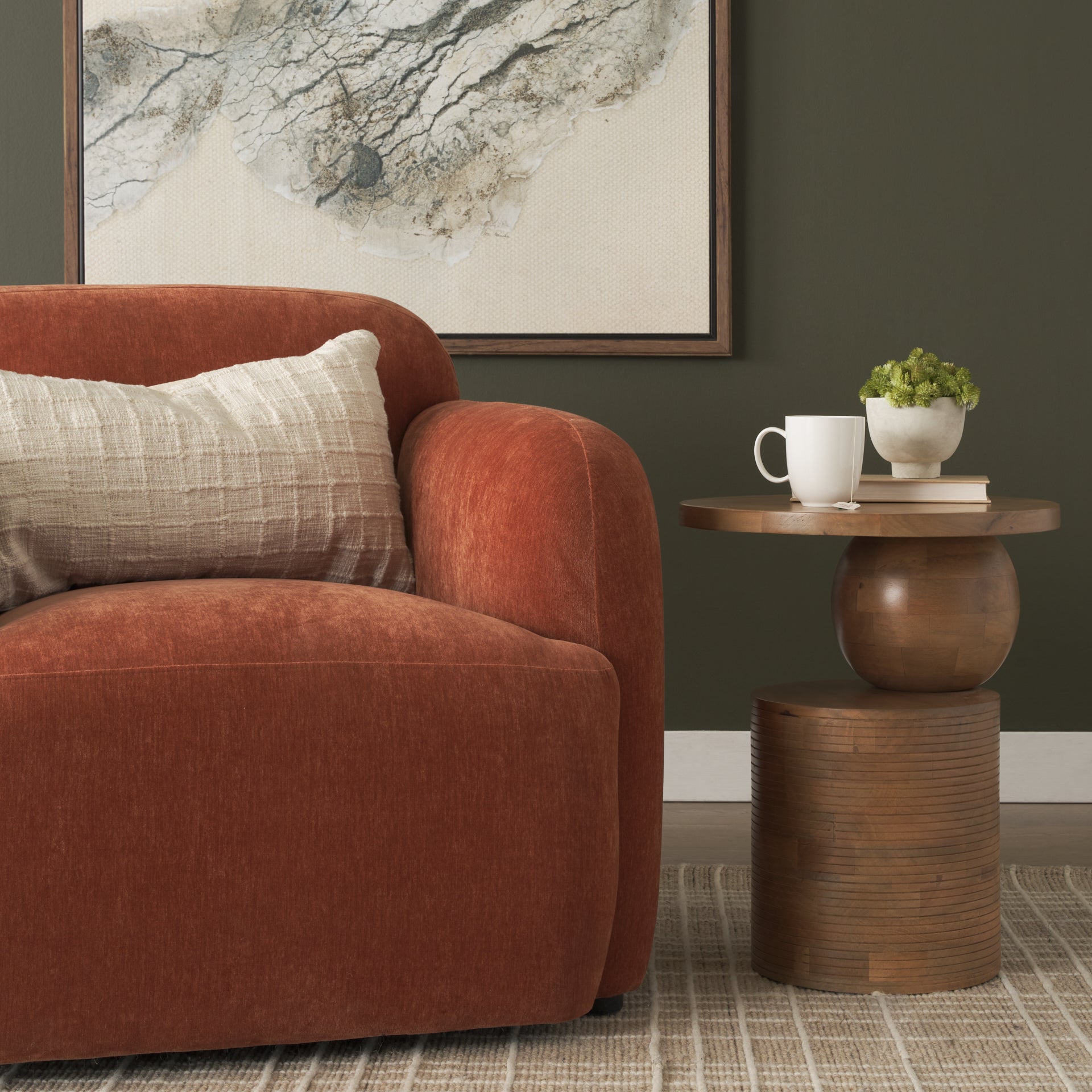 Front view of the Stack accent table featuring a circular top supported by a sculptural wood sphere and a ribbed cylindrical base