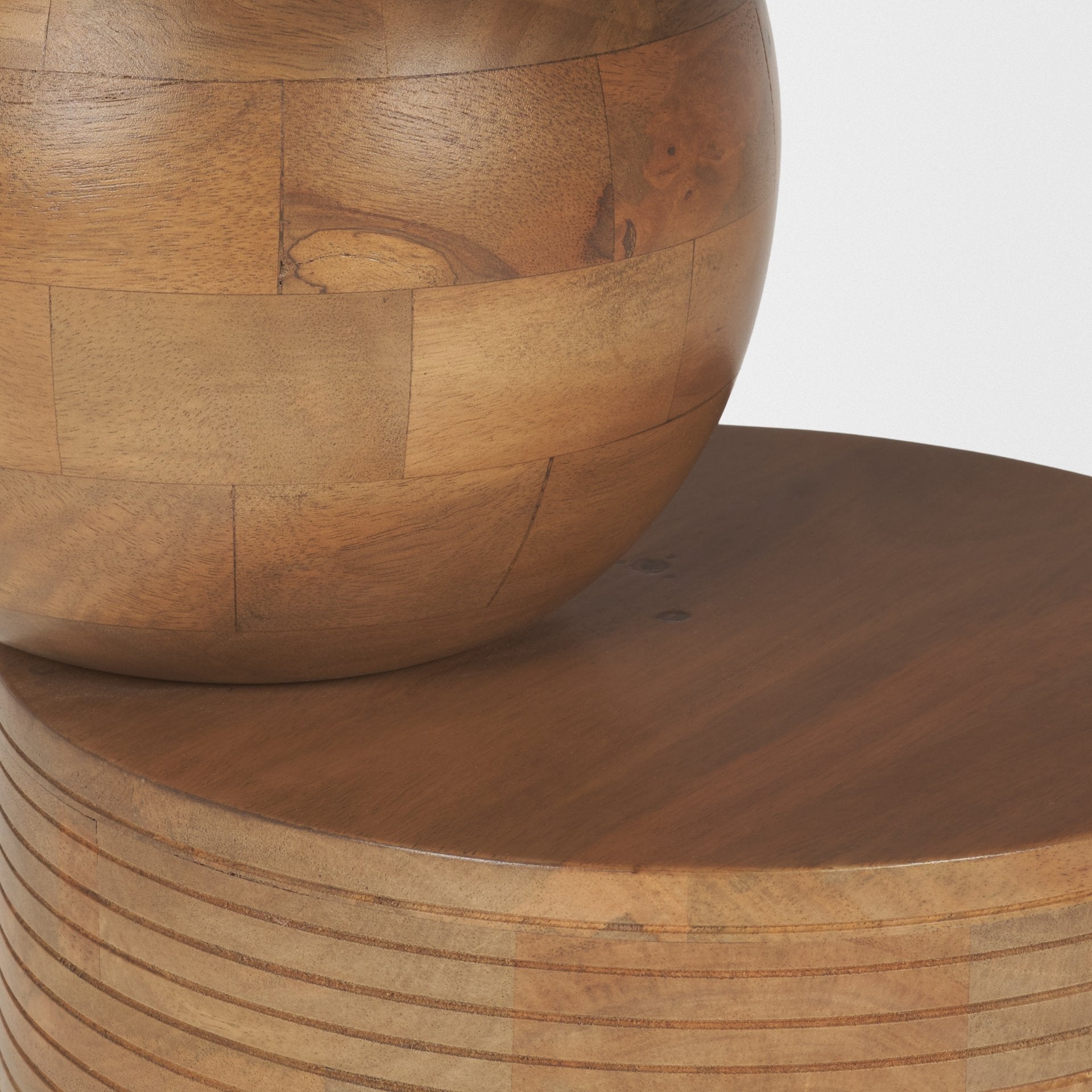 Front view of the Stack accent table featuring a circular top supported by a sculptural wood sphere and a ribbed cylindrical base