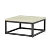 Three-quarter perspective highlighting the thick profile of the square travertine surface and the substantial dark pedestal base