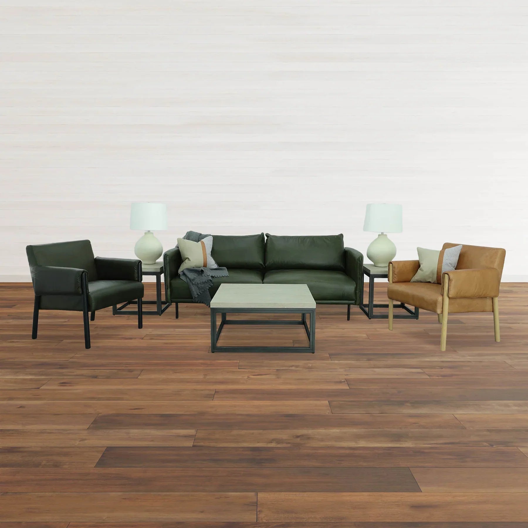 Lifestyle shot featuring the Starlight table styled next to a dark green leather sofa with mid-century modern armchairs
