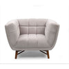 Straight-on front profile of the grey Stella chair emphasizing its symmetrical tufted design