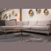 Lifestyle view showing the Stellar coffee table styled in a contemporary seating area with a light grey sectional sofa and blue rug
