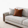 Close-up of Stille light grey fabric sofa with textured upholstery and decorative cushions in neutral tones