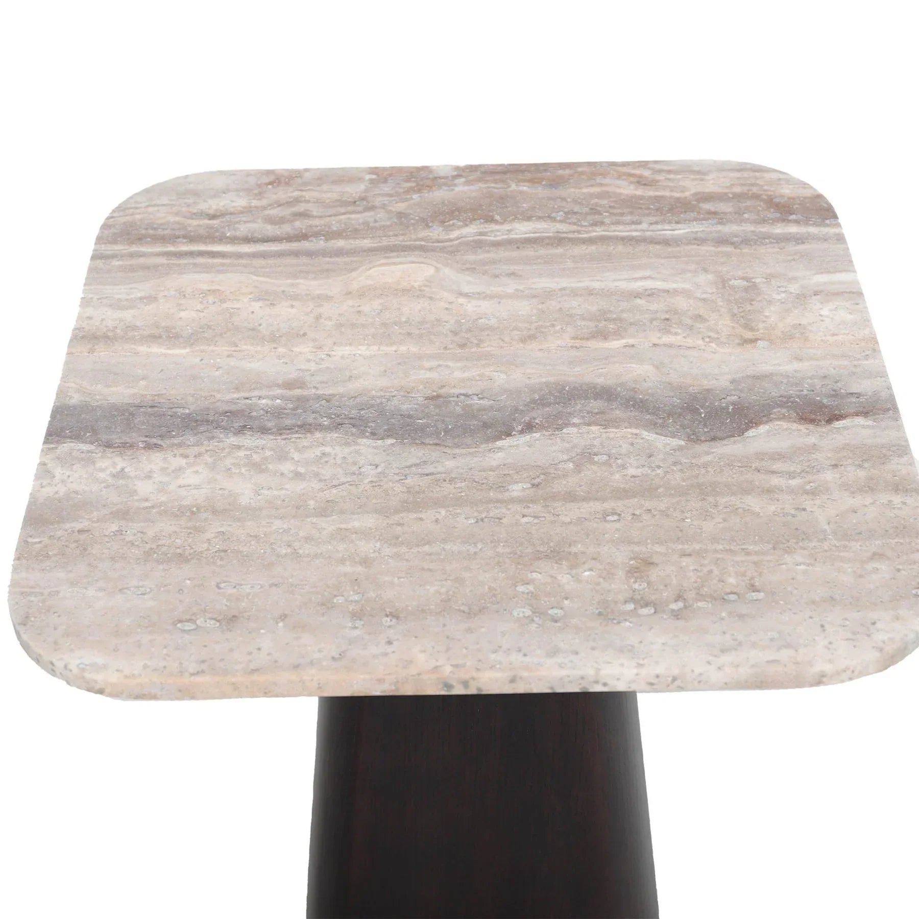 Three-quarter view of the Storm side table featuring a thin square travertine top supported by a thick tapered dark wood pedestal base