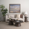 Lifestyle shot featuring the Takoda nesting tables styled in a minimalist living room with a neutral sofa and abstract artwork