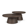 Three-quarter perspective showing the nesting capability and the tray-style rims of the circular tabletops