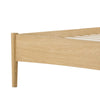 Close-up view of the tapered solid wood leg providing a minimalist and airy aesthetic