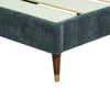 Detailed view of the mid-century inspired tapered leg featuring a decorative gold metallic tip and dark wood finish