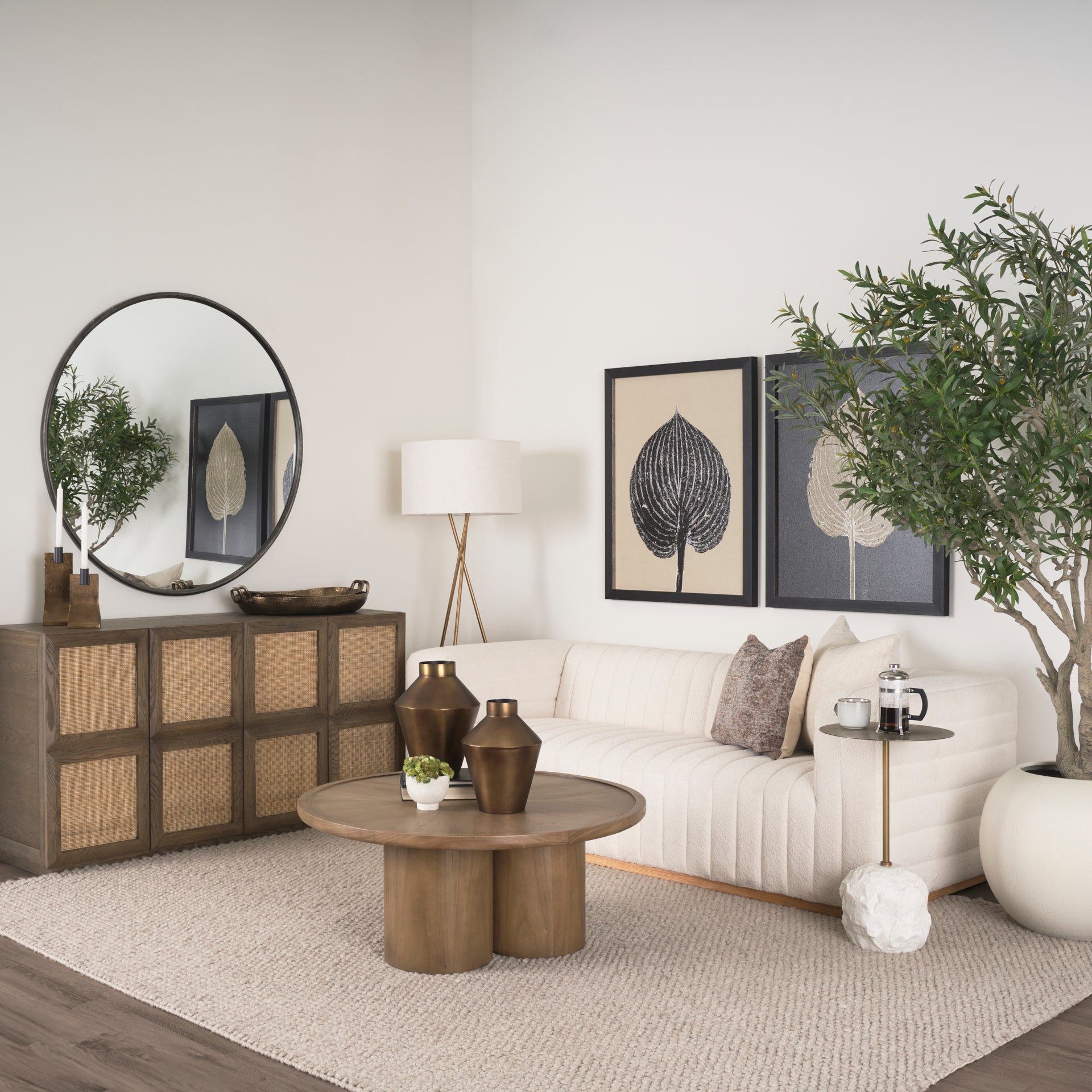 Front view of the Tavi round coffee table in a medium brown oak finish featuring a chunky double-cylinder pedestal base