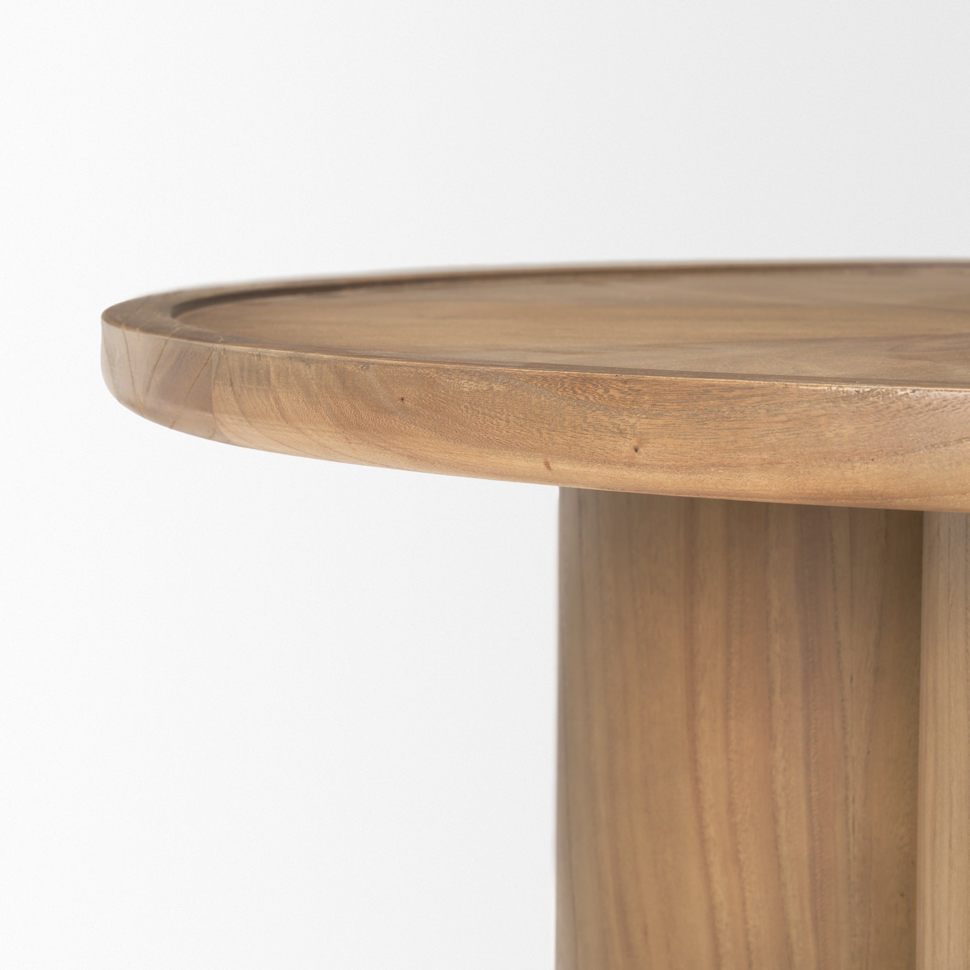 Front view of the Tavi round coffee table in a medium brown oak finish featuring a chunky double-cylinder pedestal base