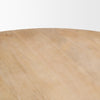 Close-up shot focusing on the smooth surface and authentic light brown wood grain patterns of the circular tabletop