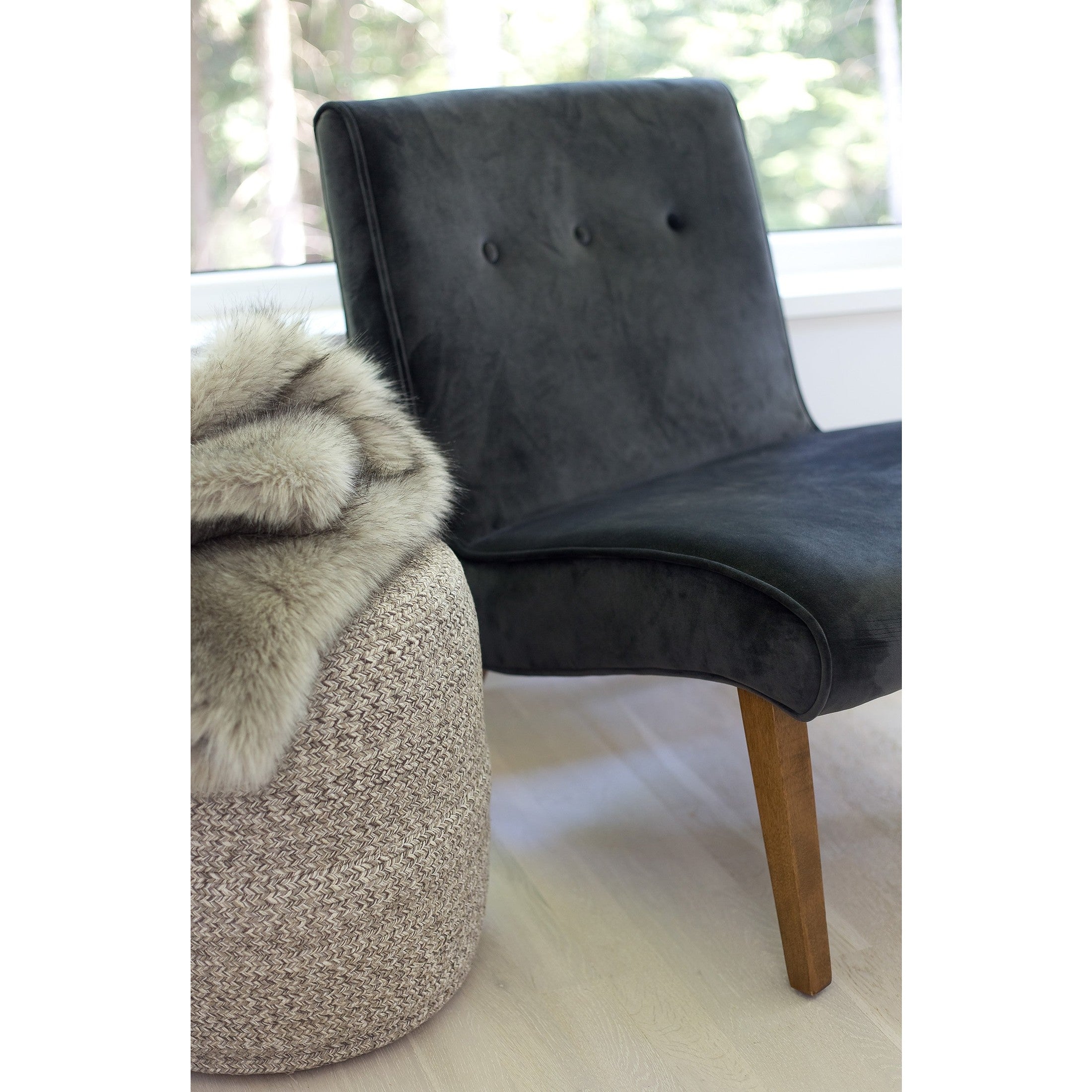 Front view of the Bohemian yarn pouf showcasing a soft braided weave in neutral cream and earth tones