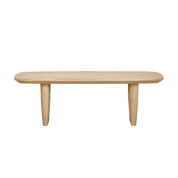 Front view of the Tonic coffee table in biscotti oak featuring a thick rectangular top and two wide block pedestal legs