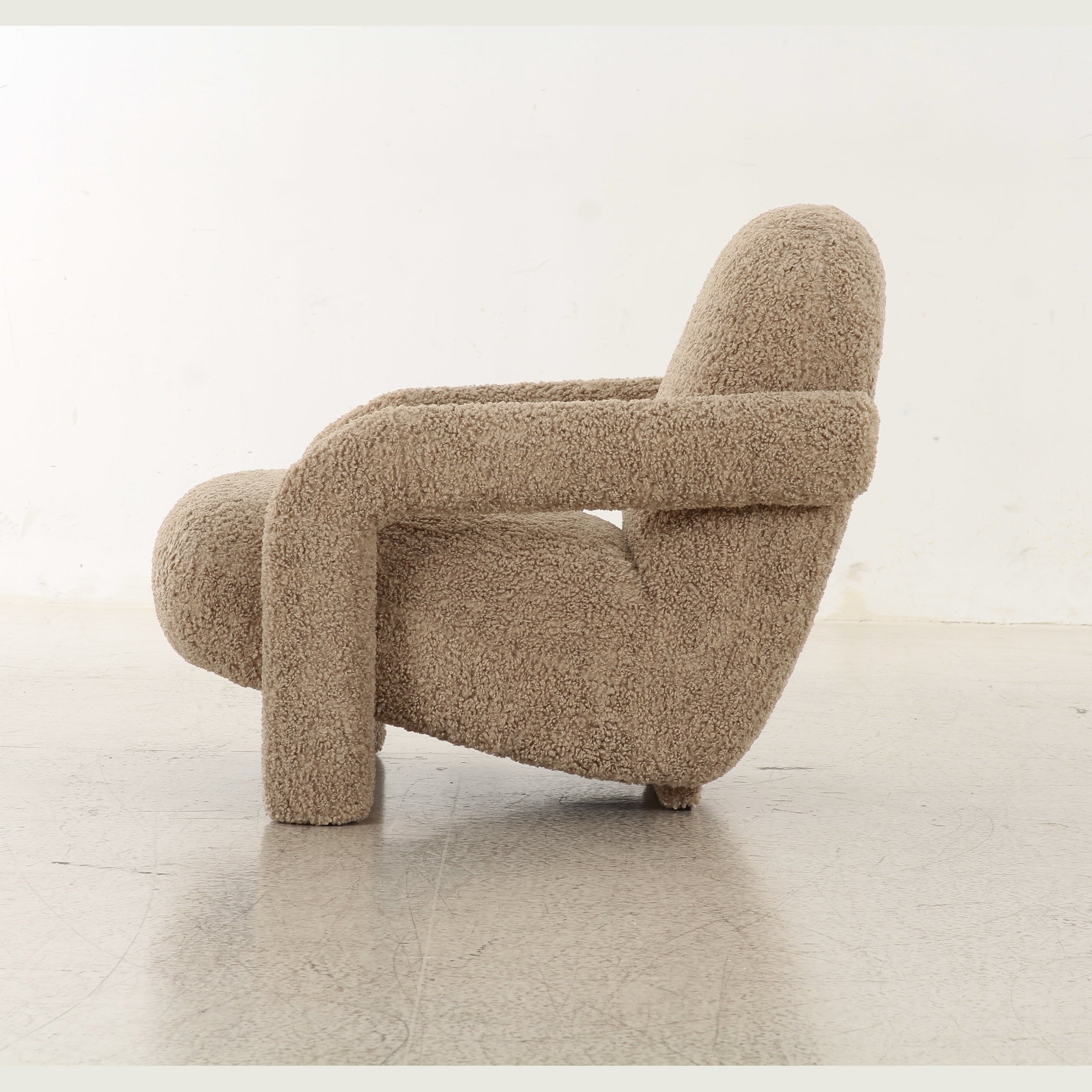 Front view of the Tornby Arm Chair in taupe teddy fabric featuring oversized tubular armrests and a rounded silhouette
