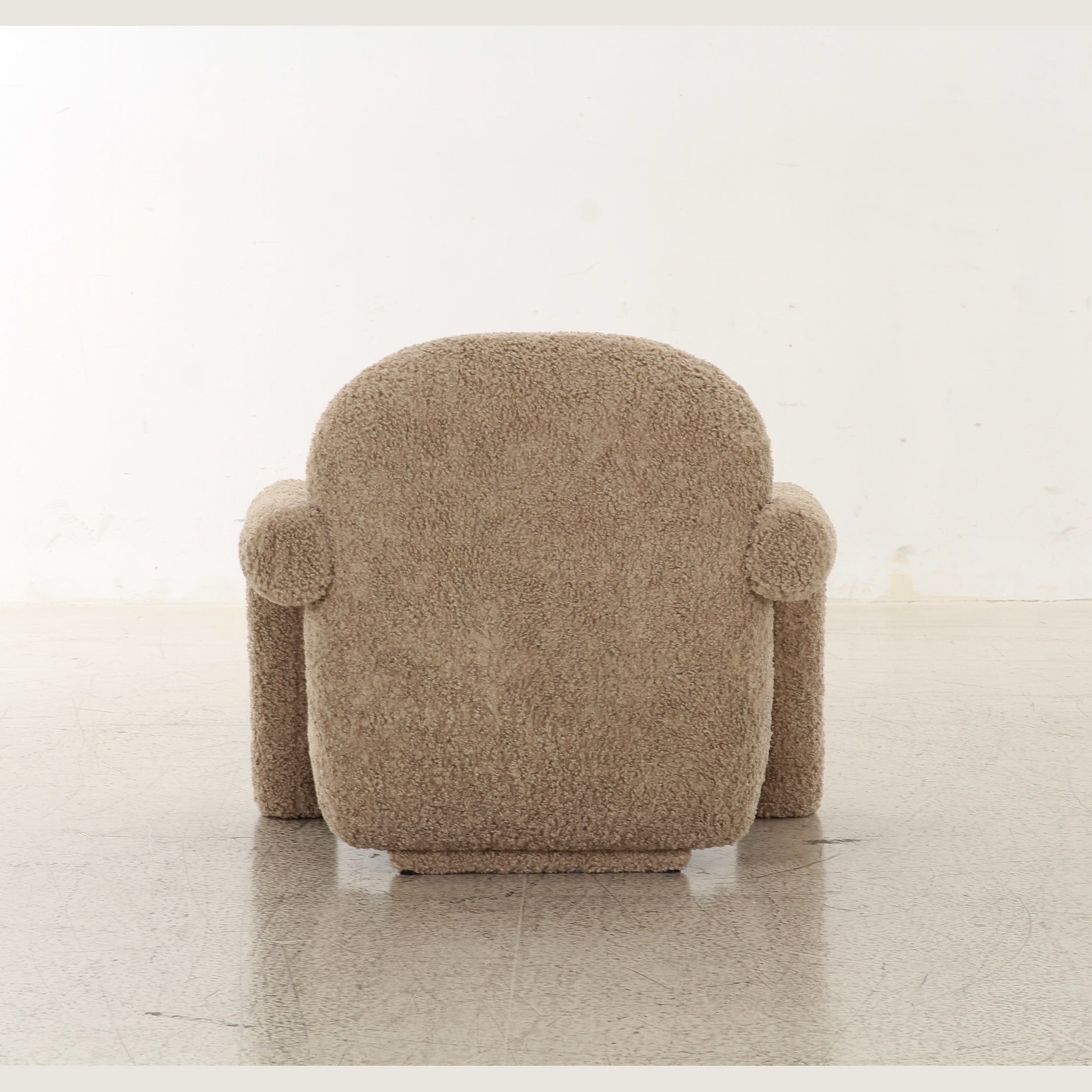 Front view of the Tornby Arm Chair in taupe teddy fabric featuring oversized tubular armrests and a rounded silhouette