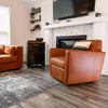 Lifestyle shot featuring the Tradition side table styled in a modern living room next to a tan leather armchair