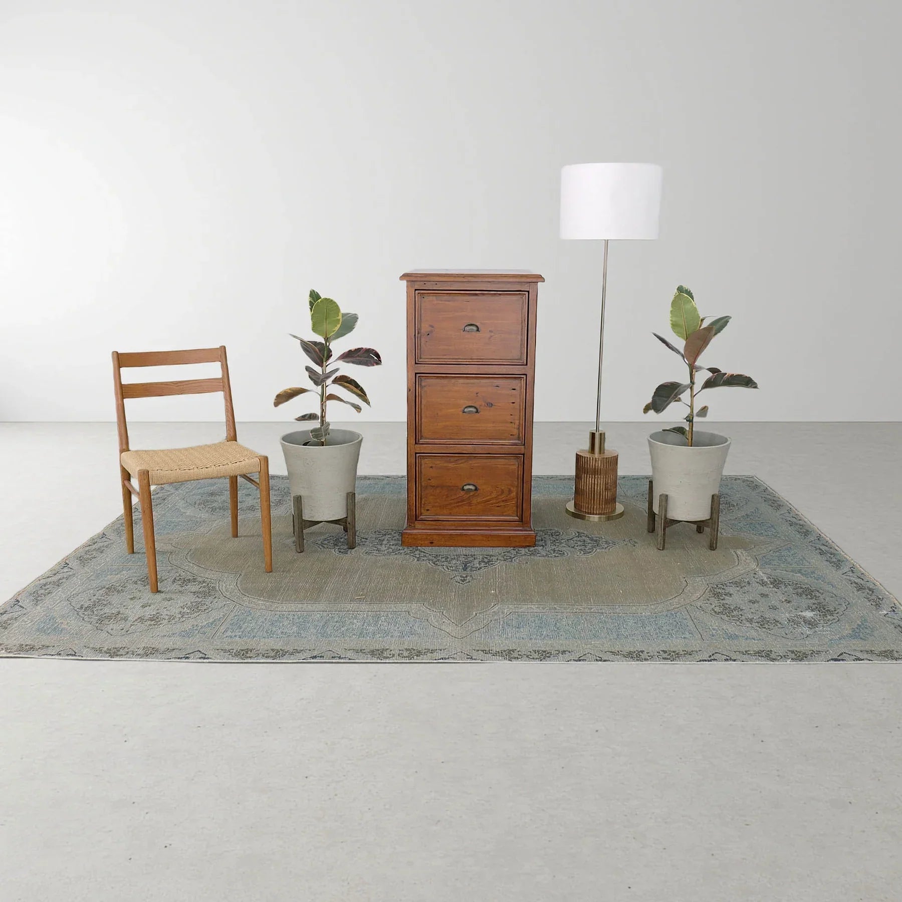 Lifestyle shot featuring the African dusk file cabinet styled in a minimalist room with indoor plants and a classic wooden chair