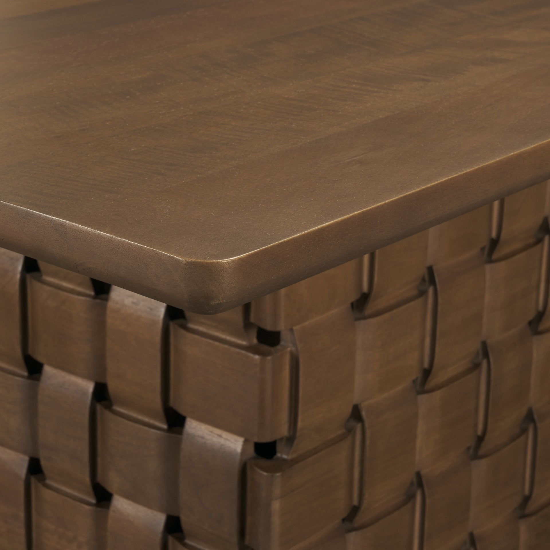 Front view of the 94 inch Trellyn solid wood dining table featuring a thin rectangular top and a decorative carved woven pedestal base