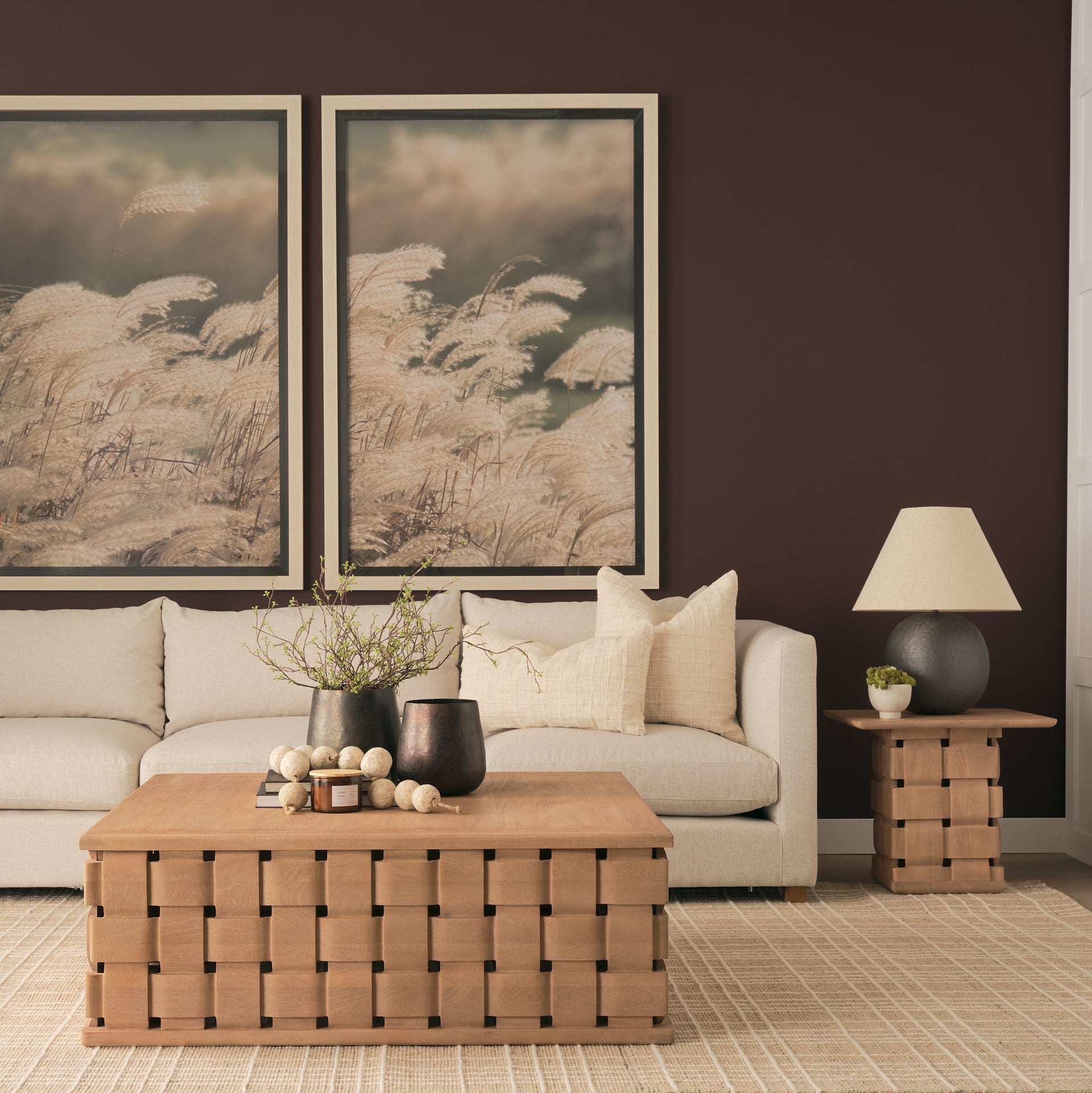 Lifestyle shot featuring the Trellyn coffee table styled in a contemporary living room with a neutral sectional sofa and abstract wall art