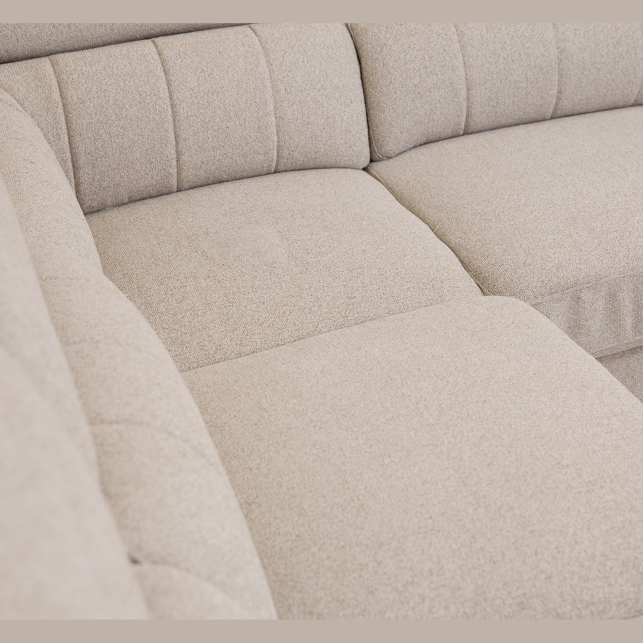 Front view of the Tristan Sleeper Sectional in Fritillary cream fabric with adjustable headrests and storage ottoman