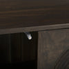 Close up of magnetic door hardware inside the dark wood accent cabinet